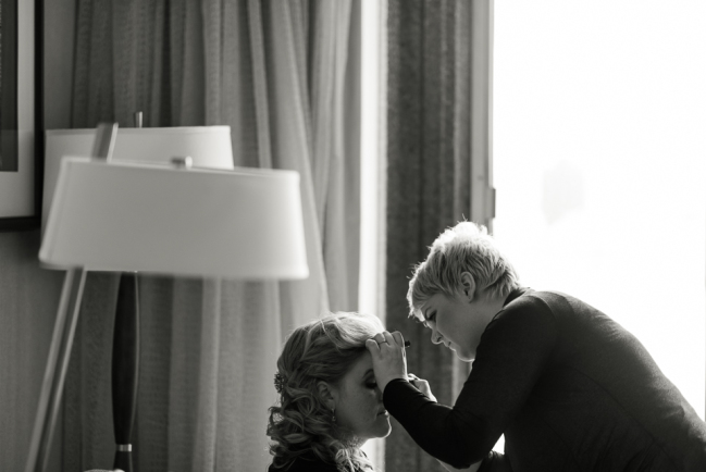 downtown denver wedding photography bride doing makeup