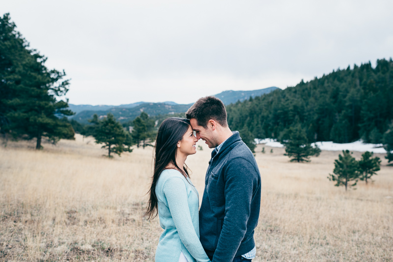 Evergreen engagement photography happy couple in a field