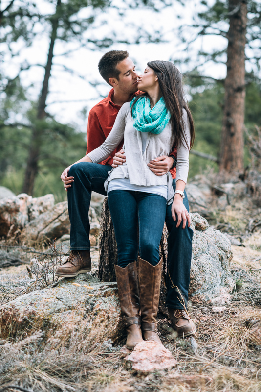 Evergreen engagement photography kissing couple in a forest