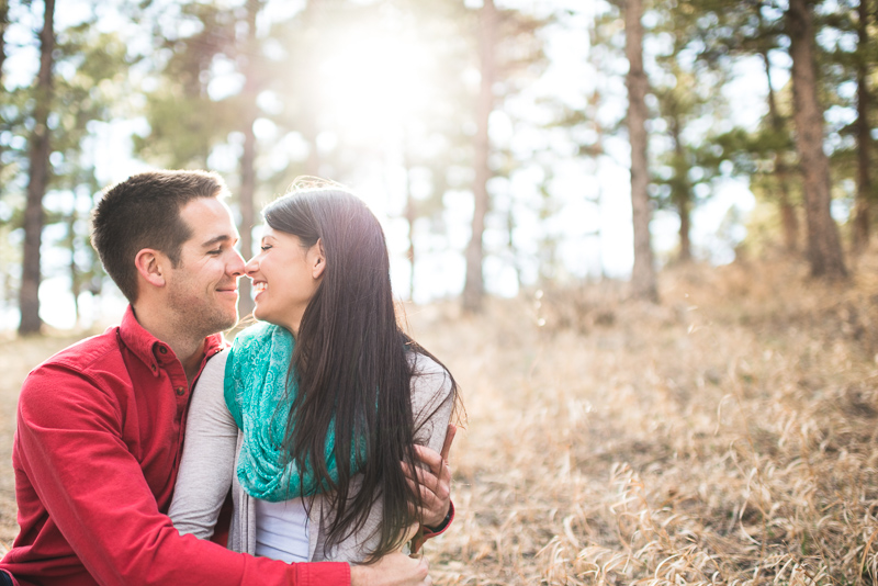Evergreen engagement photography laughing couple in a forest