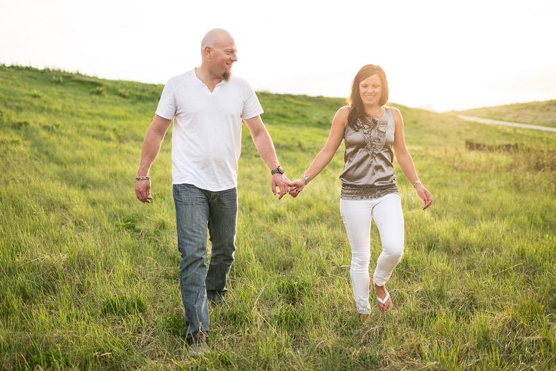 Denver Engagement Photography couple walking down grassy hill