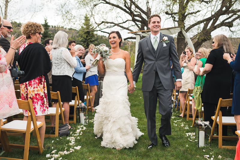 Spruce Mountain Ranch Wedding Photography happy bride and groom leaving
