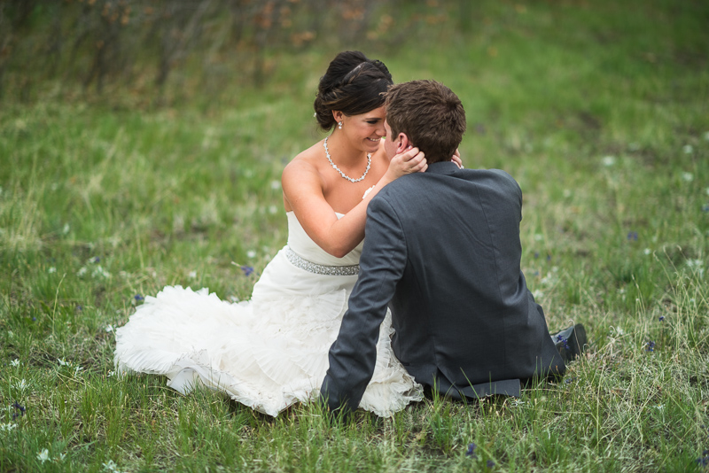 Spruce Mountain Ranch Wedding Photography bride and broom sitting in grass