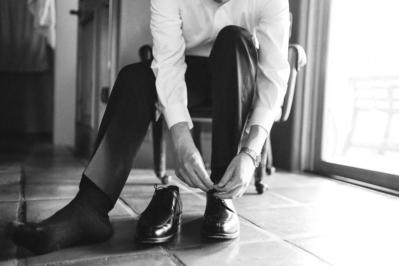 Golden Wedding Photographer groom putting on shoes