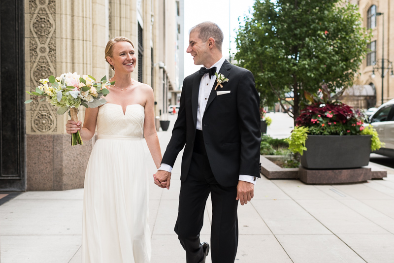 Denver Opera House Wedding Photographer bride and groom walking laughing