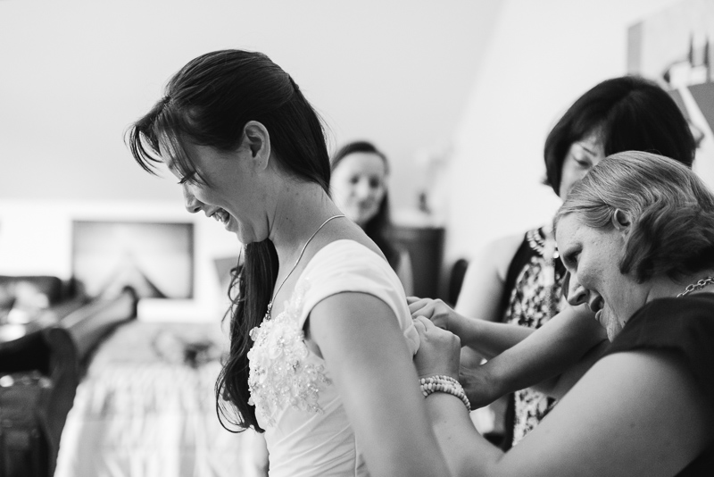bride putting on dress