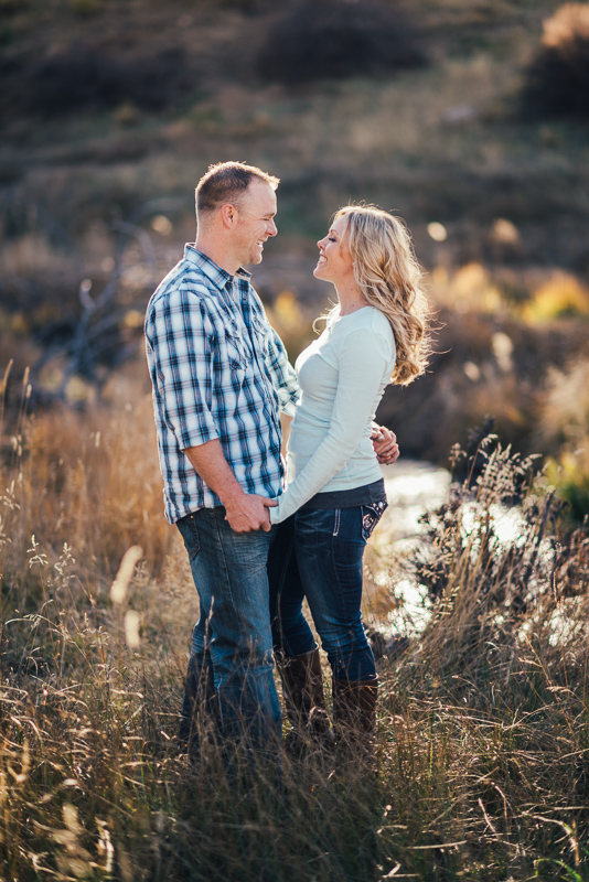 Denver Engagement Photographer couple in field with stream