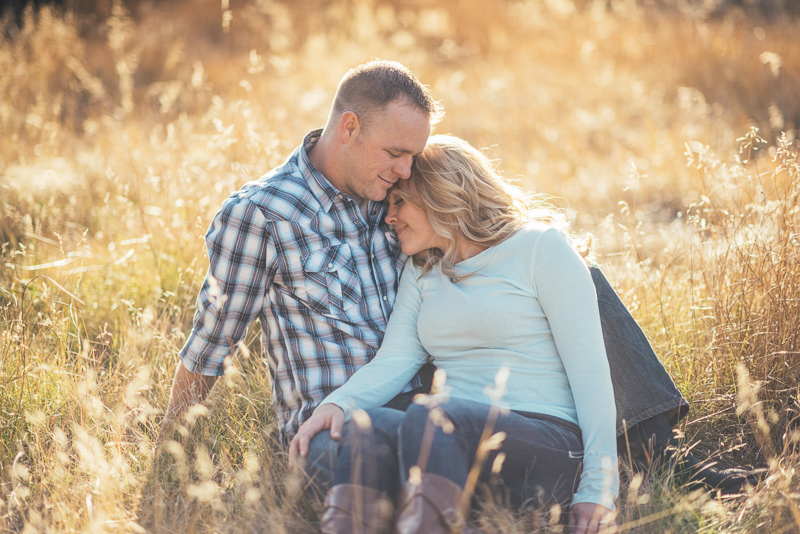 Denver Engagement Photographer couple sitting in field of grass