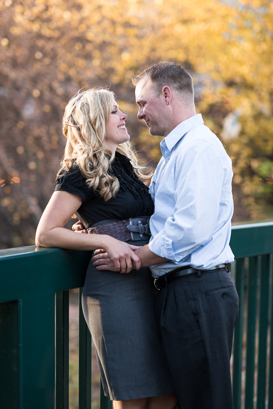 Denver Engagement Photographer standing on bridge