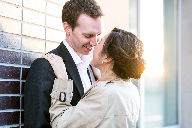 Denver engagement photography kiss with golden sunlight