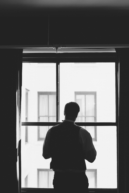 denver wedding photography groom getting ready black and white window