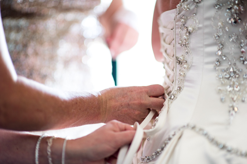 denver wedding photography putting on dress