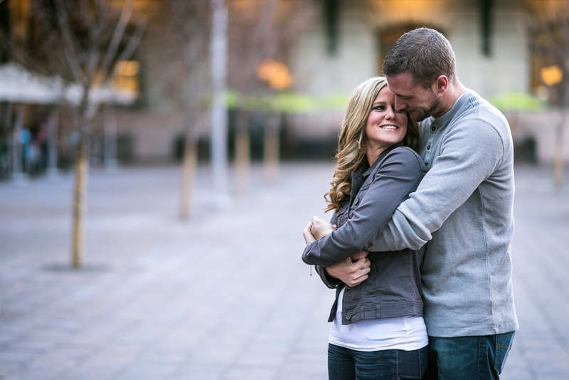 Denver Engagement Photography hugging in plaza
