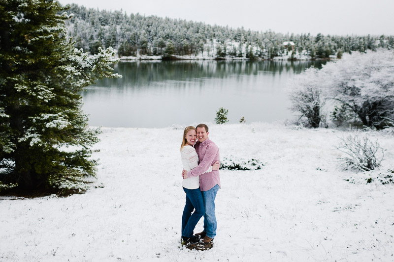 Boulder Engagement Photography standing by lake in snow