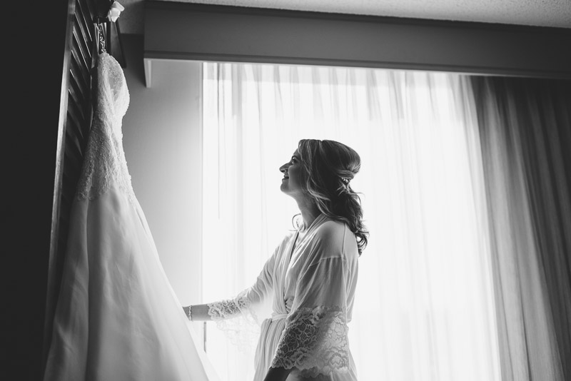 San Jose wedding photography bride looking at dress