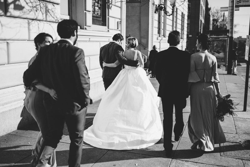 bridal party walking down san francisco street