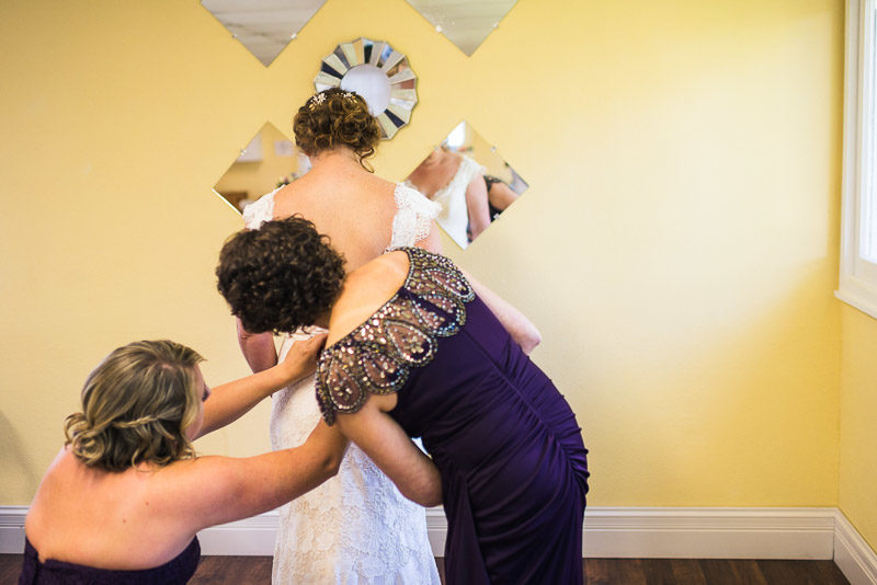 San Francisco Wedding Photography Villa Chanticleer bride putting on dress