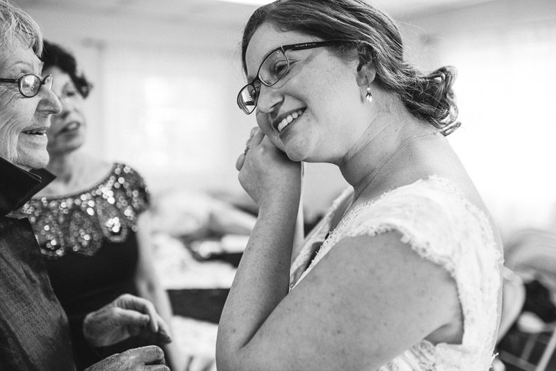 San Francisco Wedding Photography Villa Chanticleer bride putting on earrings